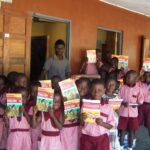 Children show off their new textbooks.
